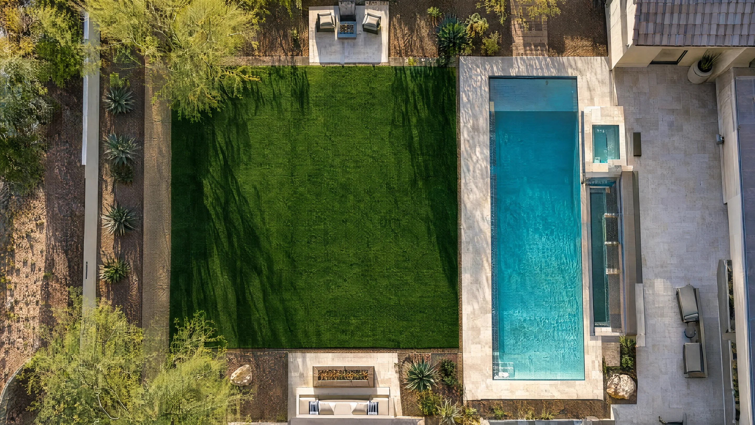 Aerial view of an Arizona backyard with a new turf lawn and pool